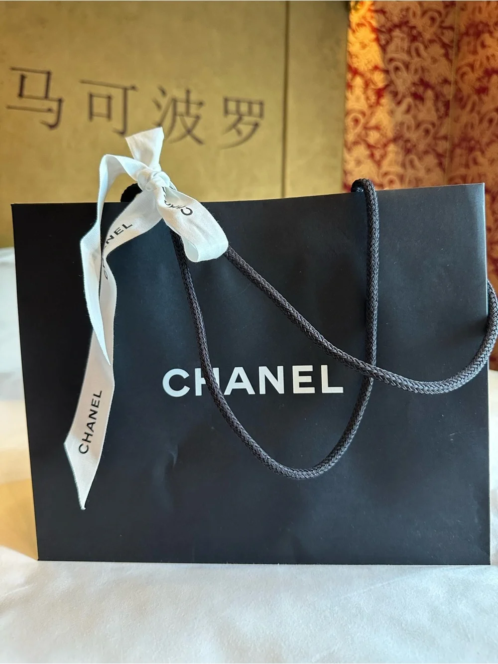 CHANEL White Camellia Hair Accessory and shopping bag